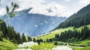 A mountain landscape with a small village nestled among green hills and dense forests. - Cozy Apartment near Ski Area in Tschagguns (Tschagguns)