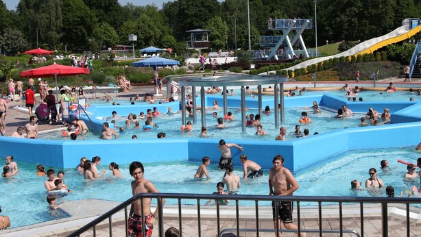A public swimming pool with multiple lanes, a water slide, and a covered seating area. - Garden Escape, Kleinwinklarn (Neunburg vorm Wald)