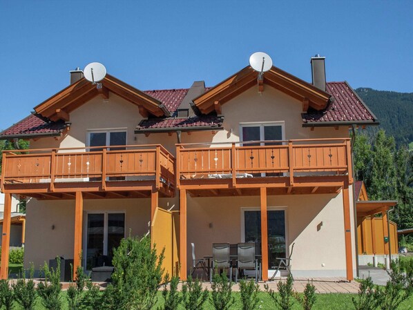 A two-story building with a balcony, a satellite dish, and a mountain view. - Chalet in ski Area in Koetschach-mauthen (Kotschach-Mauthen)