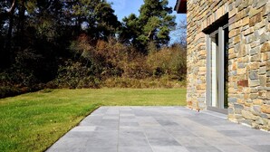 A stone building with a paved patio and a grassy lawn. - Cosy Holiday Home in Durbuy With Garden (Durbuy)