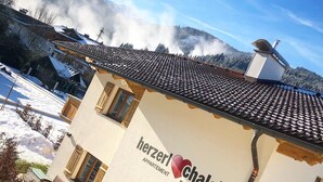 A building with a sign reading "Herzer Chalet Flachau" indicating it is a chalet. - Herzerl-Chalet Appartements (Flachau)
