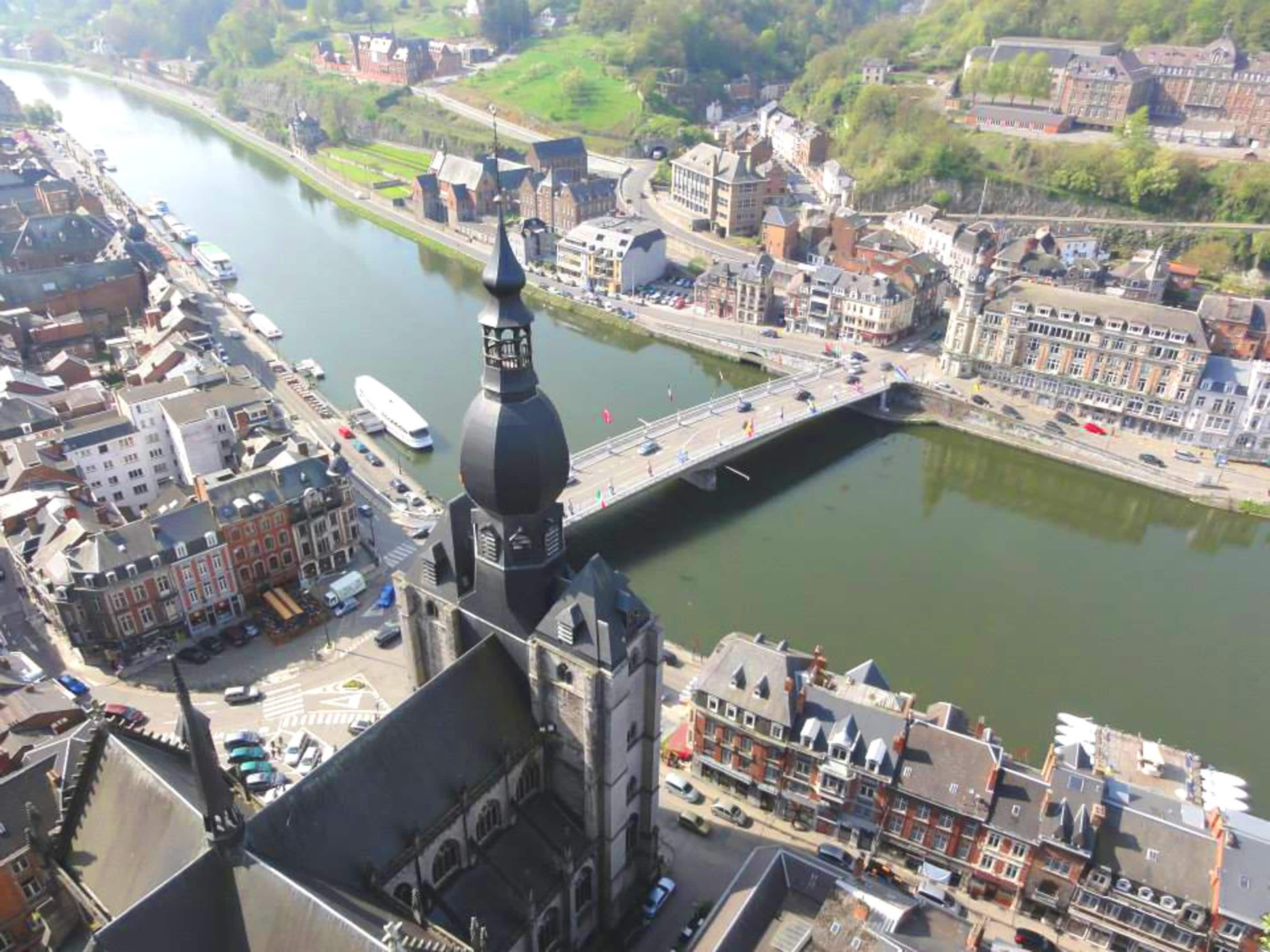 A river with a bridge, buildings, and a prominent tower.