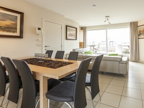 Relax in a spacious living room with a city view, dining area, and balcony.