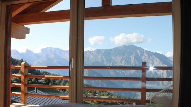 A room with a large window offering a mountain view. - Chalet in La Tzoumaz Near Ski Lift (Riddes)