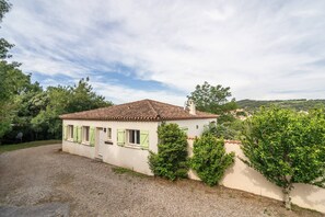 A single-story house with a tiled roof, a small porch, and a gravel driveway. - Spa Oasis Near Canal du Midi (Felines-Minervois)