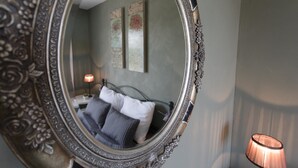 A bedroom with a bed, a nightstand, a lamp, and a mirror. - Stylish Family Villa in Felines (Boutenac)