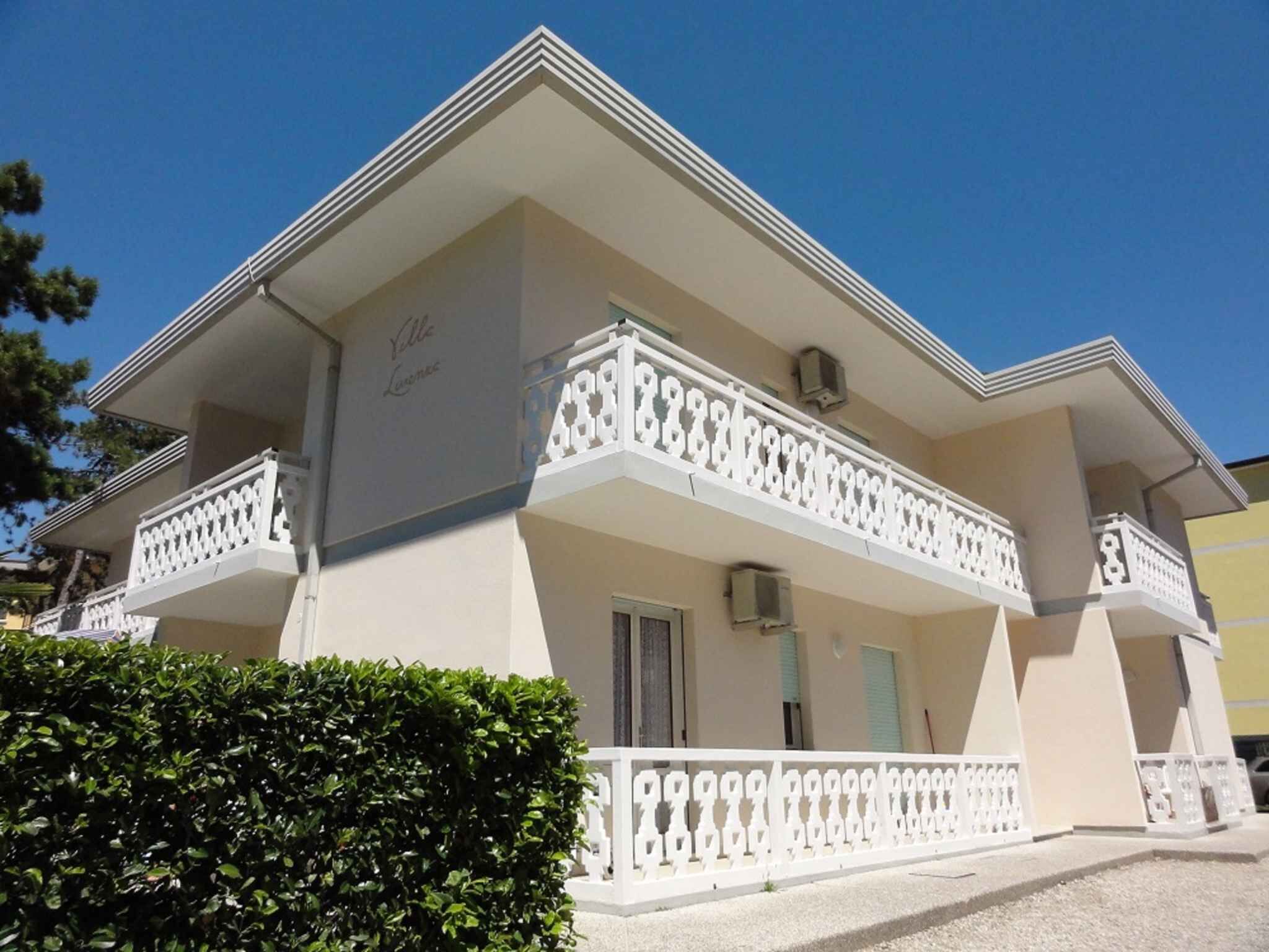 A two-story building with a balcony on the second floor.