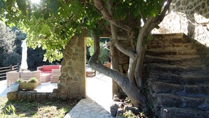 A stone pathway leading to a seating area with a tree providing shade. - Escape in Duniere-sur-eyrieux (Duniere-sur-Eyrieux)