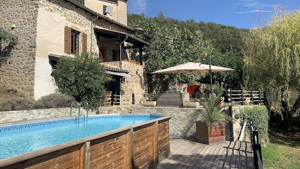A stone building with a swimming pool and outdoor seating. - Escape in Duniere-sur-eyrieux (Duniere-sur-Eyrieux)