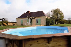 A house with a swimming pool, a wooden deck, and a small patio with outdoor furniture. - Peaceful Stay in Thedirac (Thedirac)