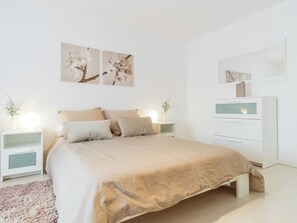 A bedroom with a bed, bedside tables, a dresser, and wall art. - Retreat in Beaumont-en-veron (Beaumont-en-Veron)