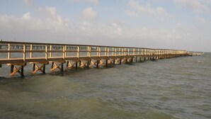 A long wooden pier extending into the water. - Bayfront Cottage Room 11 (Rockport)