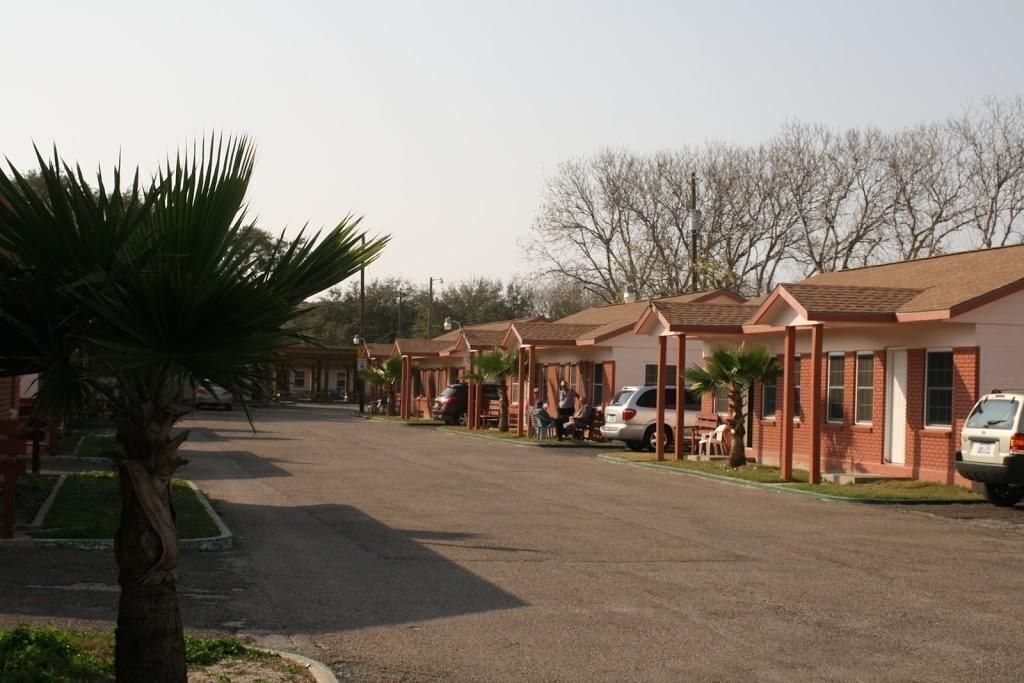 A row of single-story buildings with a uniform architectural style, featuring a flat roof and a simple, functional design.