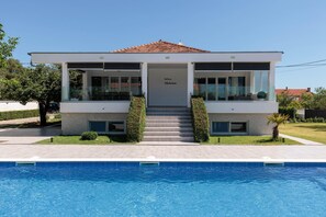 A two-story building with a swimming pool in front. - Holiday Home in Galovac With Pool (Galovac)