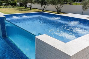 A rectangular swimming pool with clear blue water and tiled edges. - Holiday Home in Galovac With Pool (Galovac)