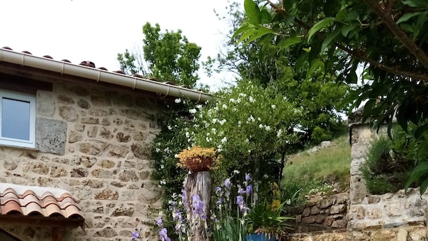A stone building with a tiled roof, a wooden door, and a stone staircase. - House in Ardeche Near Ray-pic Falls (Saint-Pierre-de-Colombier)
