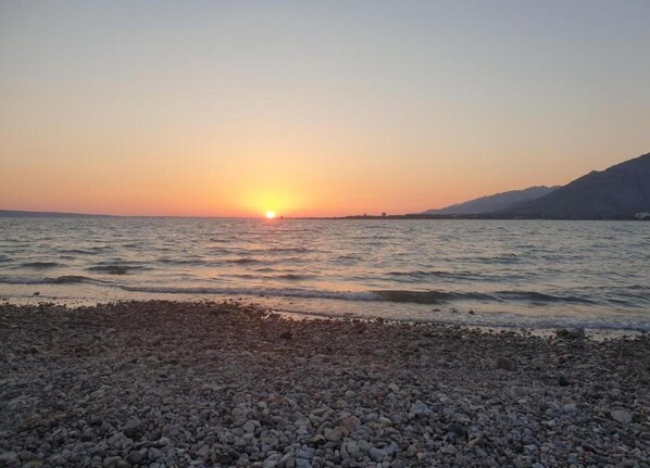 Enjoy a serene beach experience with gentle waves lapping against the shore.
