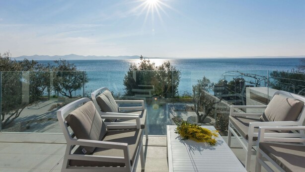 A terrace with outdoor seating and a view of the sea. - Luxurious Villa in Kozino With Fenced Garden (Zadar)