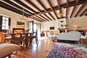 A room with wooden beams, a bed, a desk, and a TV. - Holiday Home in Le Chatelet With Pool (Le Châtelet)