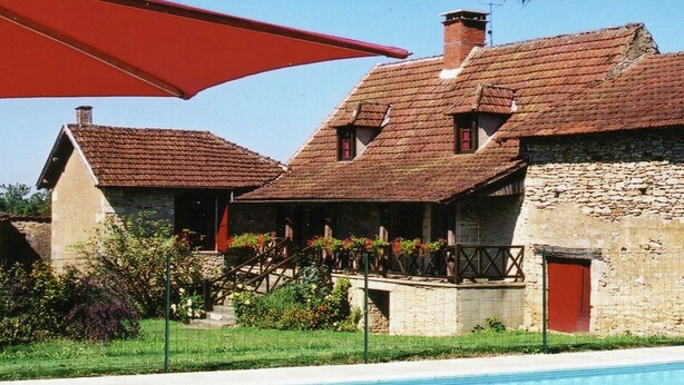 A traditional stone building with a swimming pool, a red umbrella, and a staircase leading to a porch. - Comfortable Holiday Home With Private Pool (Besse)