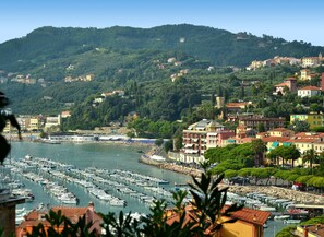 A coastal town with a marina filled with boats, surrounded by lush green hills and colorful buildings. - Cozy Holiday Home in Lerici near Sea (Lerici)