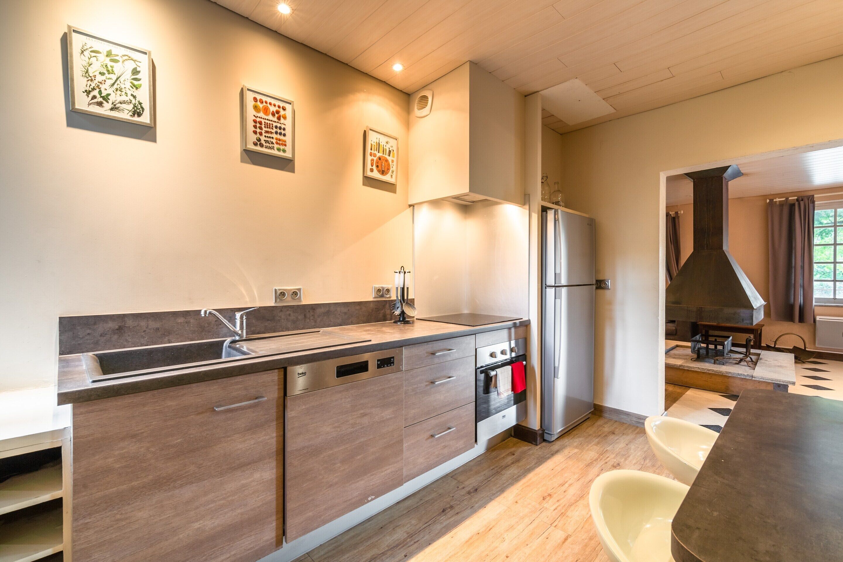 A modern kitchen with a dishwasher, oven, and a large island.