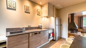 A modern kitchen with a dishwasher, oven, and a large island.
