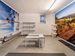 Enjoy a serene mountain view from the comfort of this stylish room, featuring a desk, shelving unit, and plush rug.