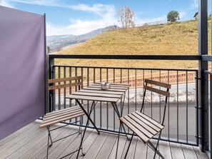 Enjoy a peaceful outdoor space with a balcony featuring a table and chairs.