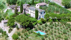An aerial view of a property with multiple buildings, a swimming pool, and surrounding greenery. - Cozy Farmhouse with Swimming Pool in Le Tolfe near Florence (Siena)