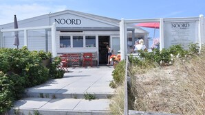A building named NOORD with a signboard listing prices for various services. - Comfortable Holiday Home in Bergen (Bergen)
