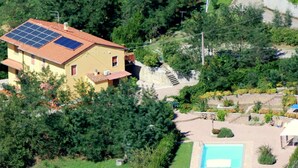 A house with a solar panel roof, a swimming pool, and a garden. - Sunlit Home With Pool (Fucecchio)