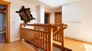 A room with a wooden staircase, a skylight, and a mounted fur piece on the wall. - Warm Apartment in Uttendorf Salzburg near Ski Area (Uttendorf)