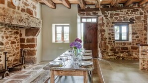 A rustic room with a long wooden table set for dining, stone walls, and a wooden ceiling. - Tranquil Holiday Home With Private Pool (Teillots)