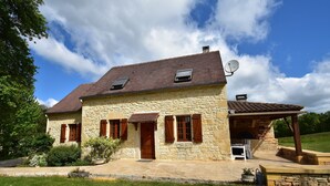 A stone house with a tiled roof, a covered porch, and a satellite dish. - Spacious Holiday Home With Private Pool (Uzech)