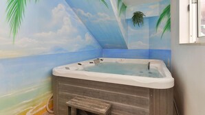 A room with a jacuzzi, a wooden bench, and a mural of a beach scene. - Holiday Home Bibinje Near the Sea (Bibinje)