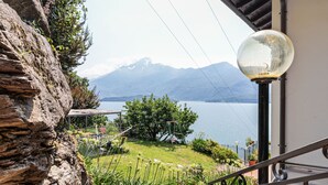 A balcony with a view of a lake and mountains.