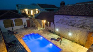 A swimming pool with steps, surrounded by stone walls and a few lounge chairs. - Holiday Home Near Vrana Lake and Adriatic Sea (Benkovac)