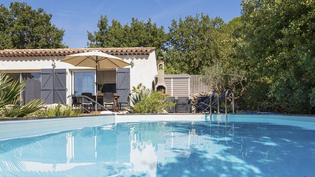 A swimming pool with a covered patio area, a barbecue grill, and a small tower structure. - Holiday Home in Brignoles With Private Pool (Brignoles)
