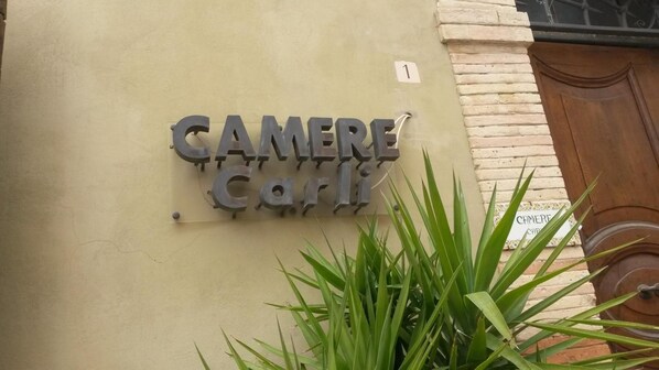 A building sign with the words "CAMERE Carli" indicating a hotel or lodging establishment. - Camere Carli (Assisi)