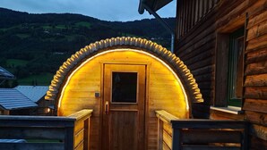 A wooden cabin with a circular entrance and a wooden door. - Spacious Holiday Home in Styria near Kreischberg Ski Area (Sankt Georgen am Kreischberg)