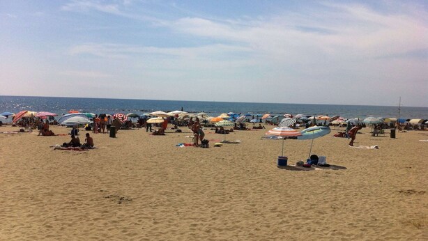A beach with numerous umbrellas and people relaxing. - Belvilla by OYO Serena (Massa)