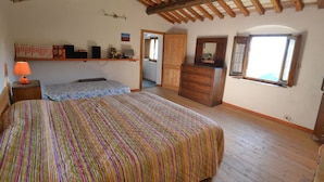 A bedroom with a large bed, a dresser, a mirror, and a window. - Cottage in Marliana With Private Pool (Marliana)