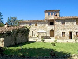 A stone building with a tiled roof, a small tower, and a grassy courtyard. - Holiday Home, Bucine With Pool (Monte San Savino)
