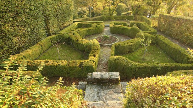 A meticulously landscaped garden with geometric hedge patterns and a central stone pathway. - Home Near Bouillon Castle (Bouillon)