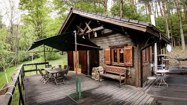 A wooden cabin with a deck, outdoor seating, and a grill area. - Chalet Near Bitche With Private Sauna (Bousseviller)