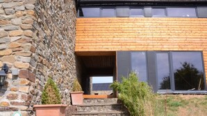 A stone building with wooden steps leading to a modern entrance. - Charming Ardennes Getaway (Stoumont)