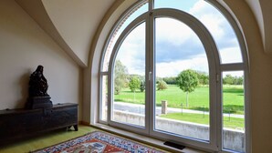 A room with a large arched window overlooking a green landscape. - Spacious Villa in Zingem With Garden (Vresse-sur-Semois)
