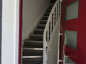 A staircase with white railings leading to a landing. - Pretty Apartment in Oppenau near Black Forest National Park (Oppenau)