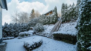 A snow-covered outdoor area with a wooden staircase leading up to a building. - Large Holiday Home near Winterberg with Garden, Terrace, & Garage (Winterberg)